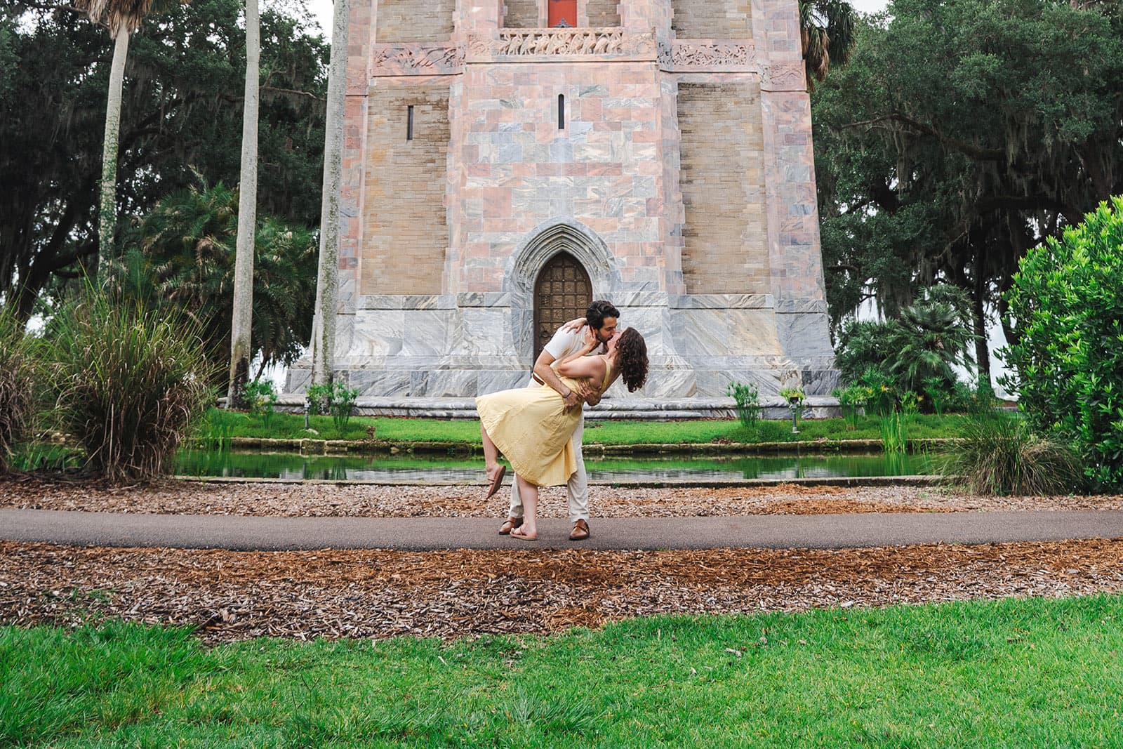 Couple dip kissing in front of Bok Tower